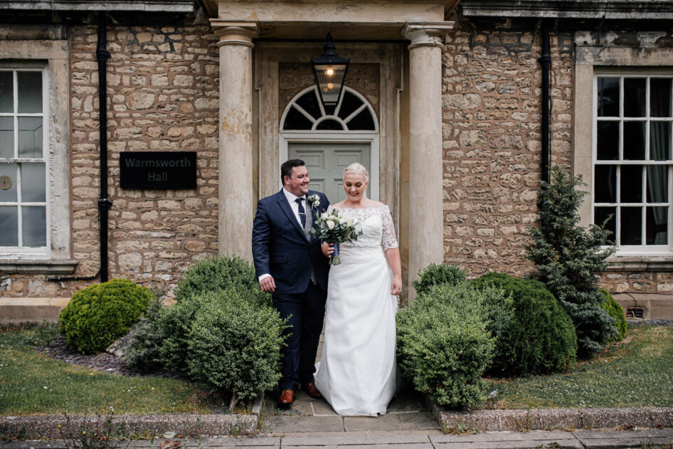 Newlyweds outside the main door at Warmsworth Hall