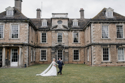 Bride and groom walking outside Warmsworth Hall