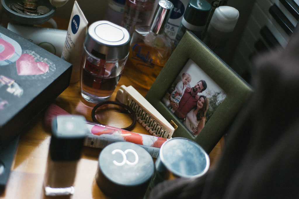 Wedding makeup accessories on desk and a family photograph
