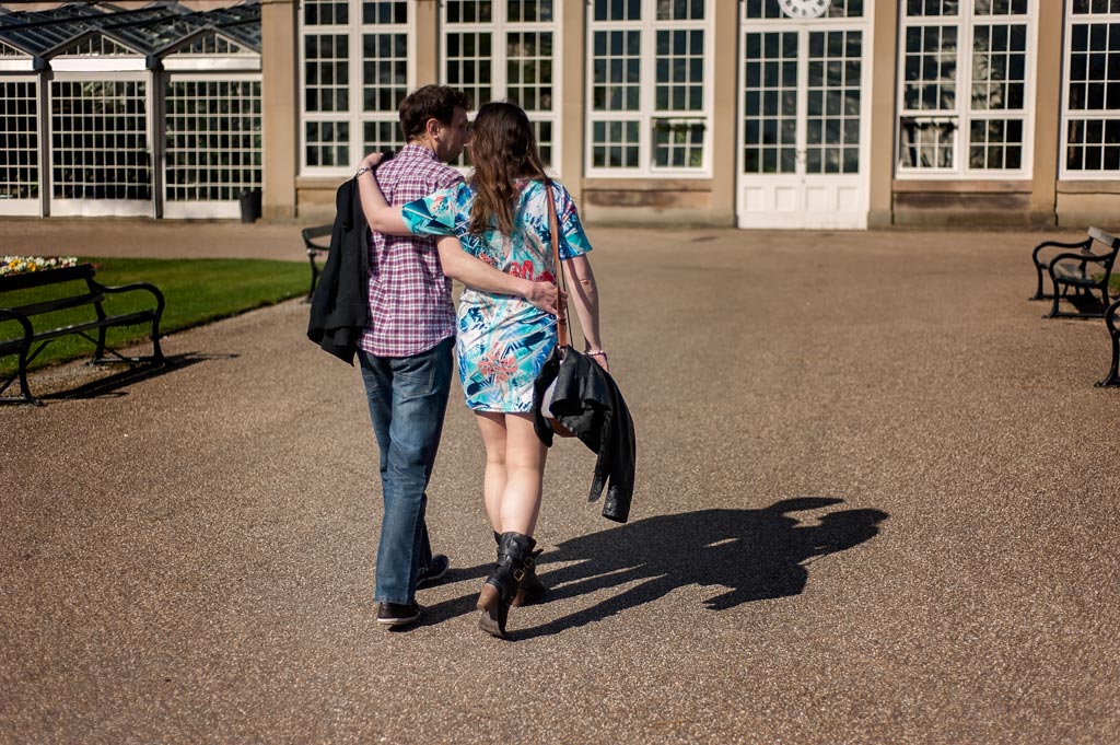 Engaged couple walking at Sheffield Botanical Gardens