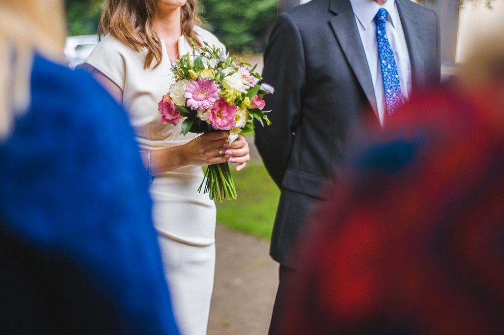 Bride and groom with wedding flowers