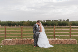 Bride and groom posing for a wedding photo at Norton Common Farm