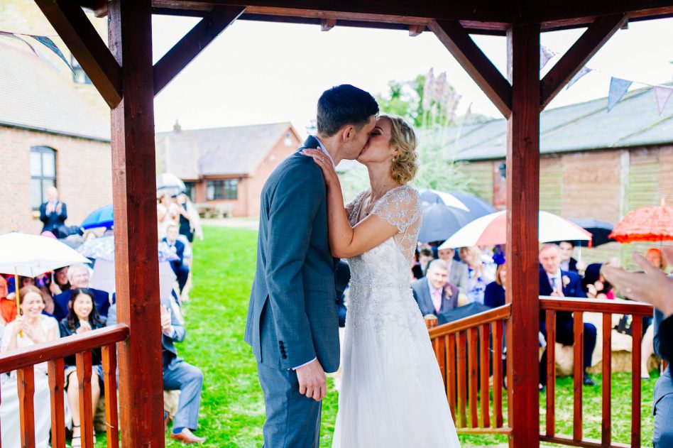Bride and groom kissing at wedding ceremony