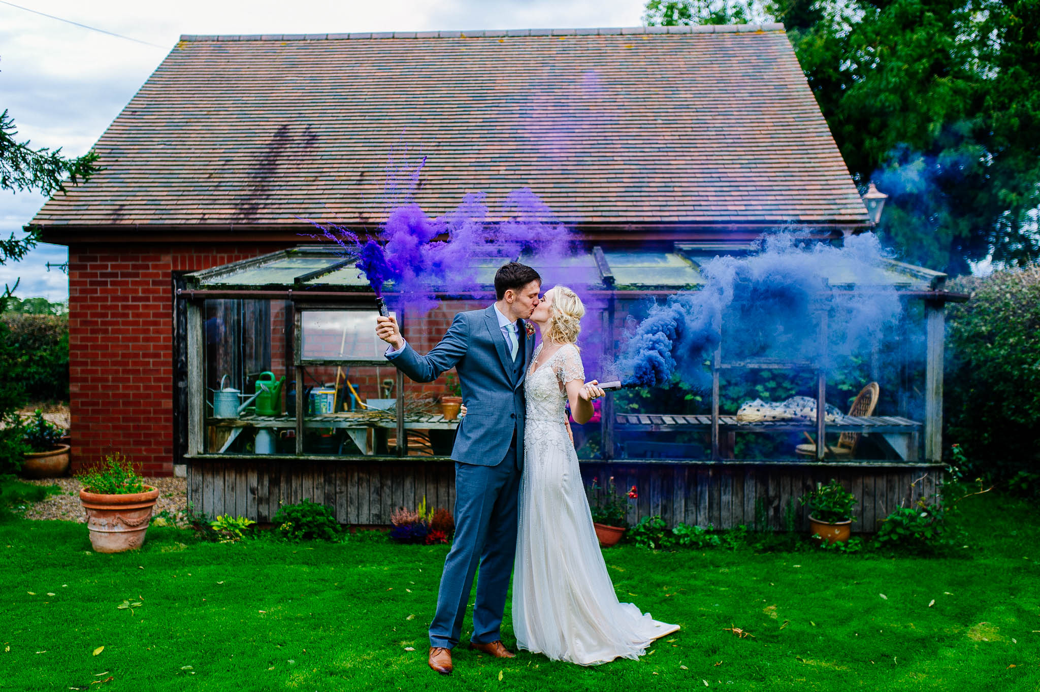 Married couple holding smoke bombs at Fishlake Mill