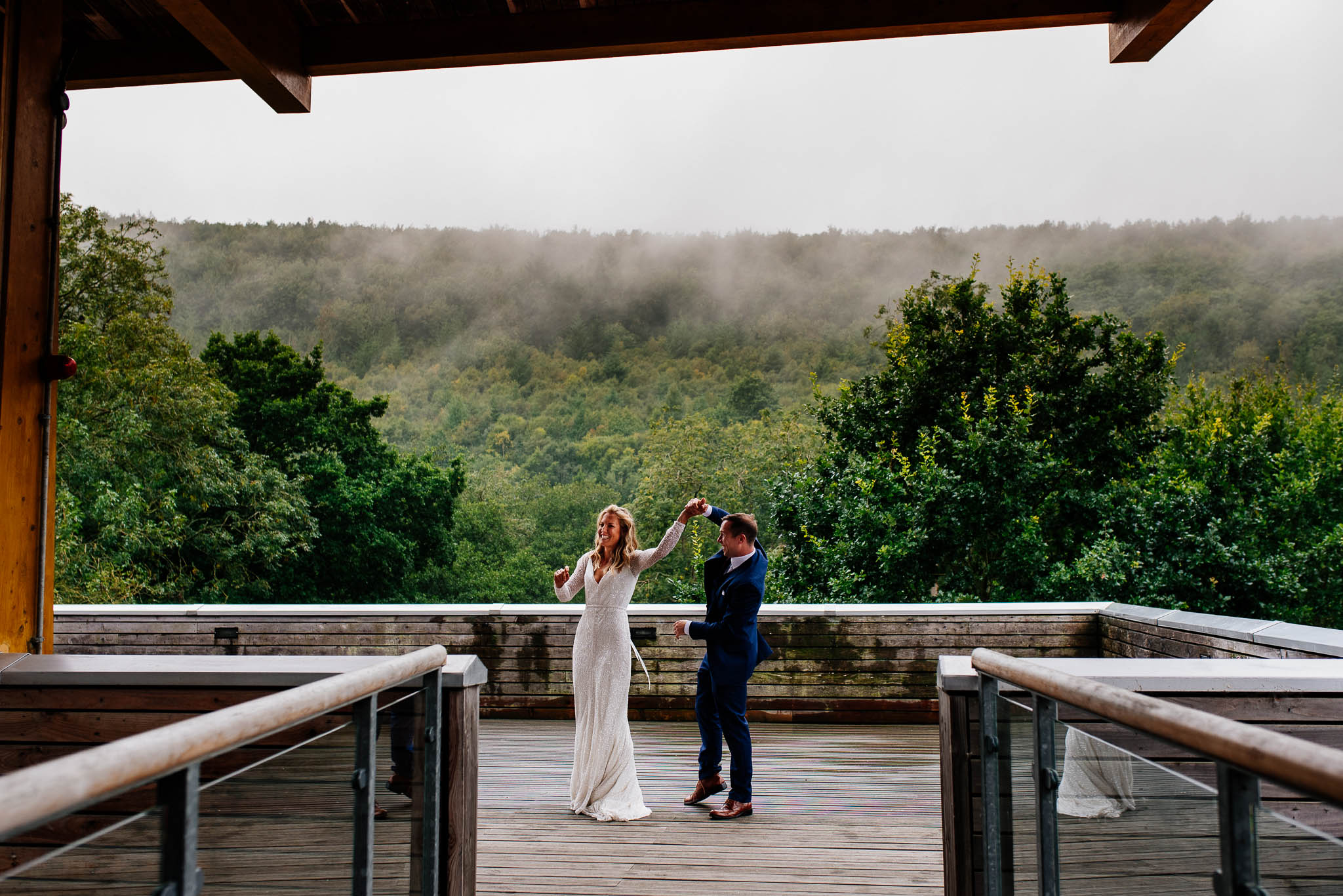 Newly married couple dancing on a viewing balcony in the middle of Dalby Forest in Yorkshire.