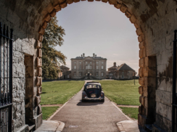 Bride arriving at Cusworth Hall wedding venue in a vintage VW Beetle