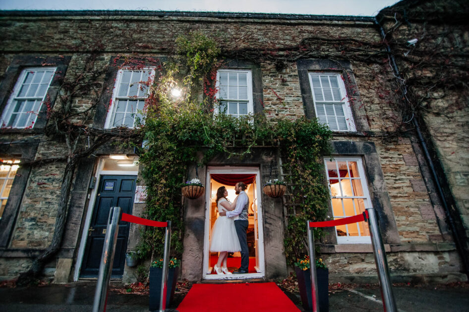 Bride and groom posing outside The Old Rectory in Hemsworth
