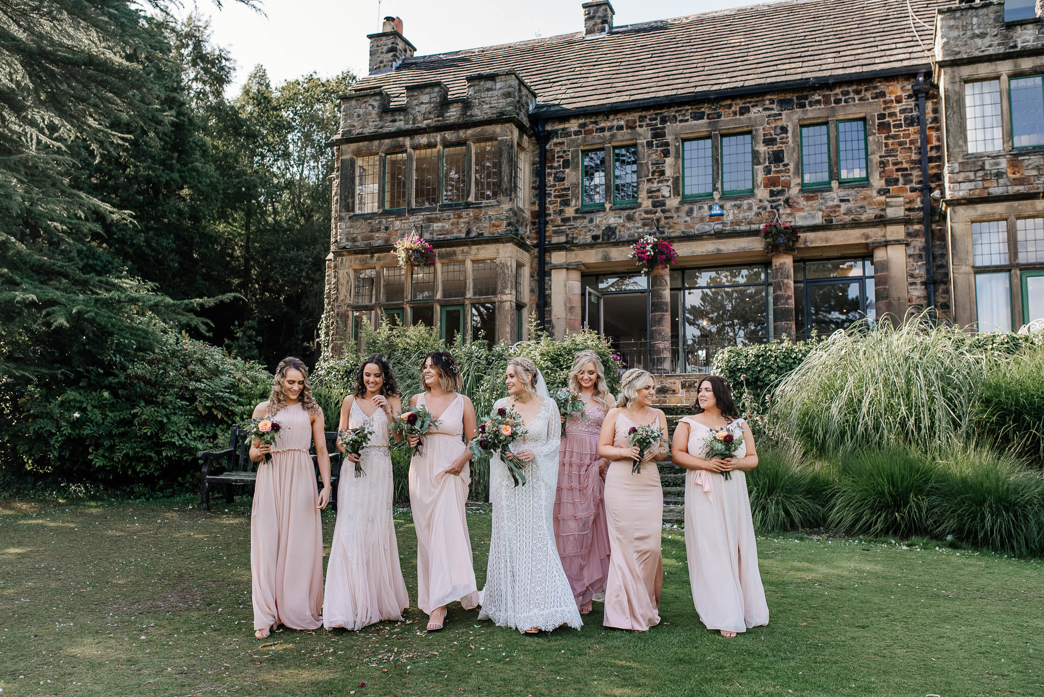 Bride with bridesmaids outside Whirlowbrook hall wedding venue