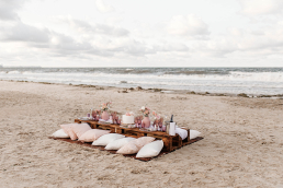 A beach wedding setup using wooden pallets