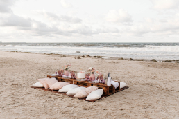 A beach wedding setup using wooden pallets