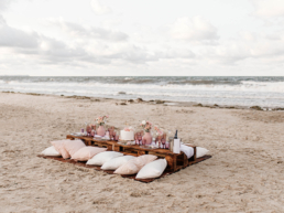 A beach wedding setup using wooden pallets
