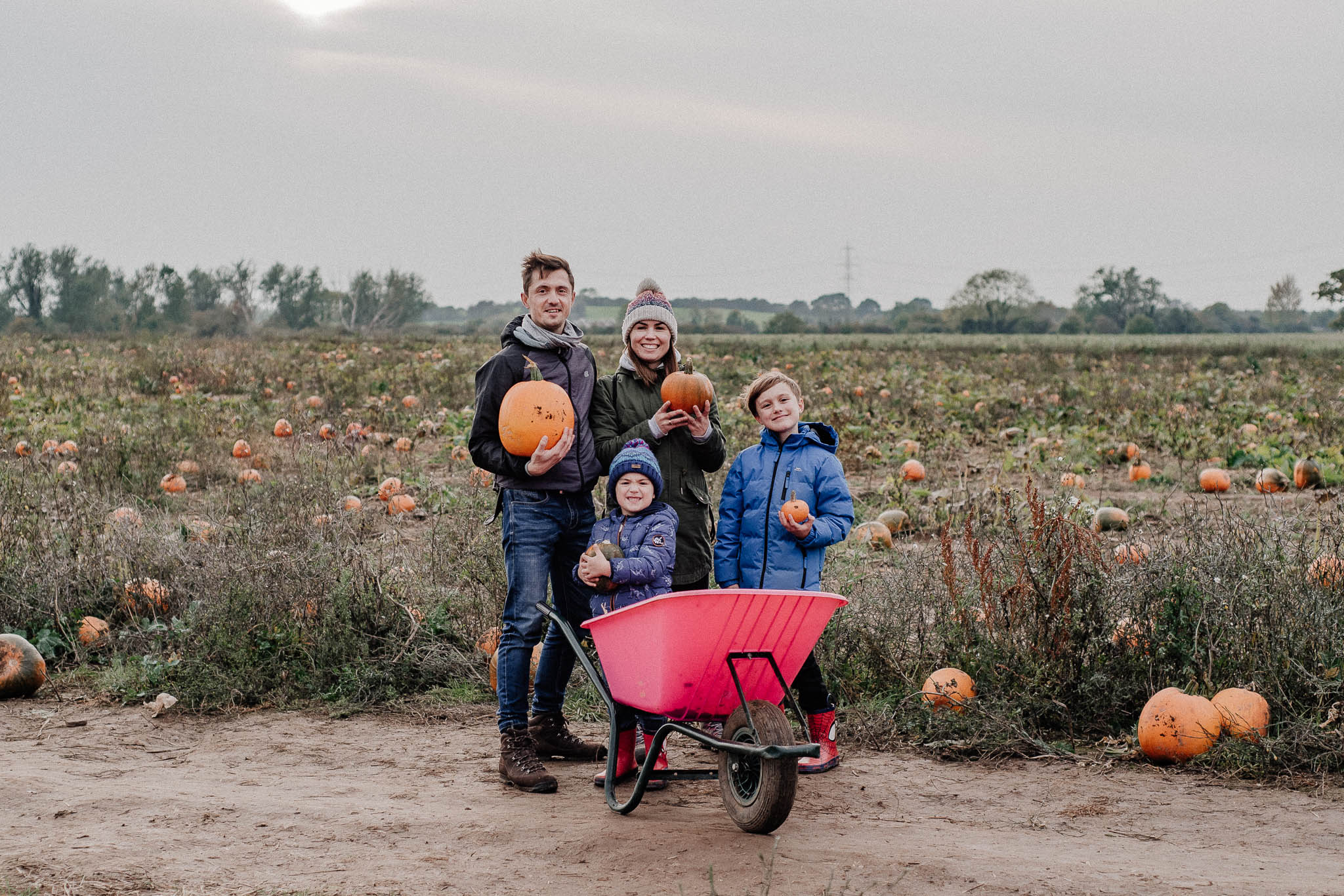 Family photo during pumpkin picking