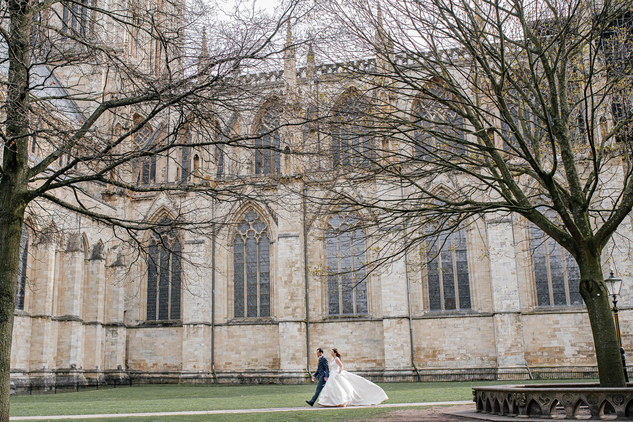 Bride and groom walking outside York Minster