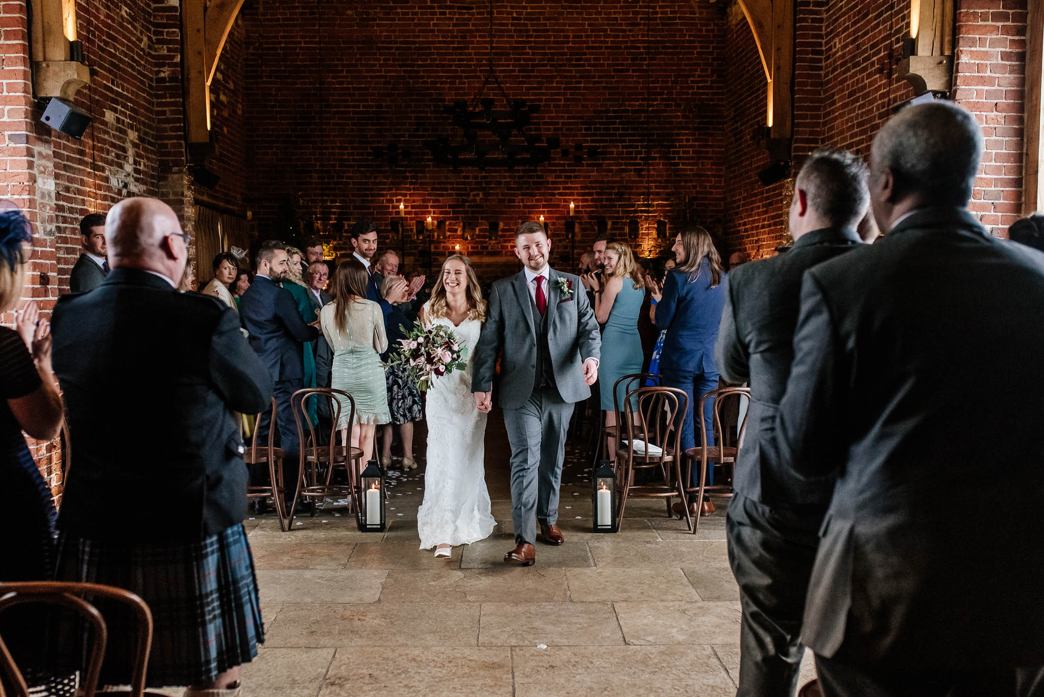 Bride and groom walking after a wedding ceremony in the main barn