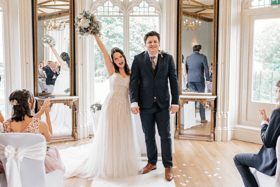 Newly married couple exiting their wedding ceremony at Kenwood Hall.