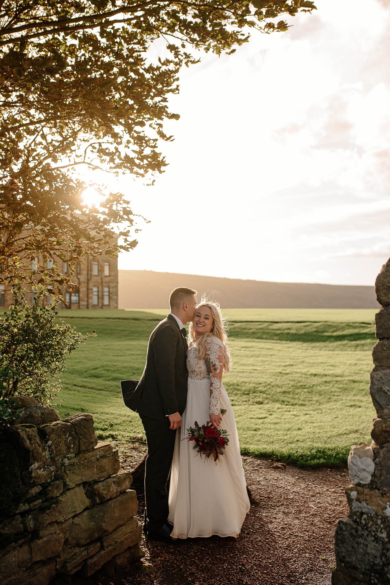 Bride and groom celebrating at Ravens Hall wedding venue