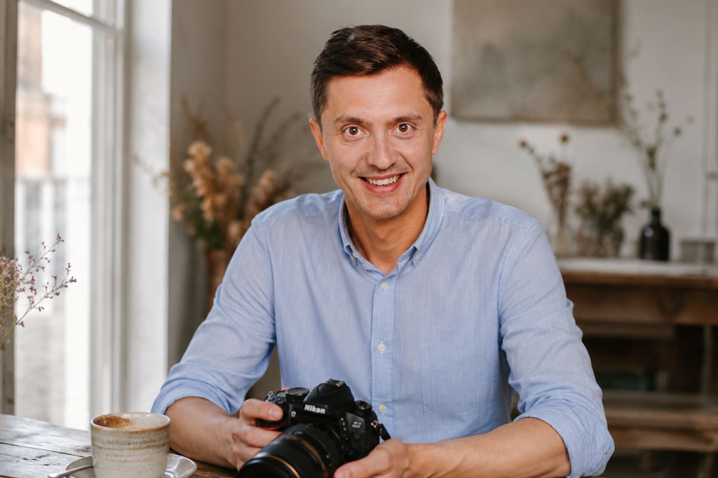 Michal Ufniak, wedding photographer, sitting with his camera